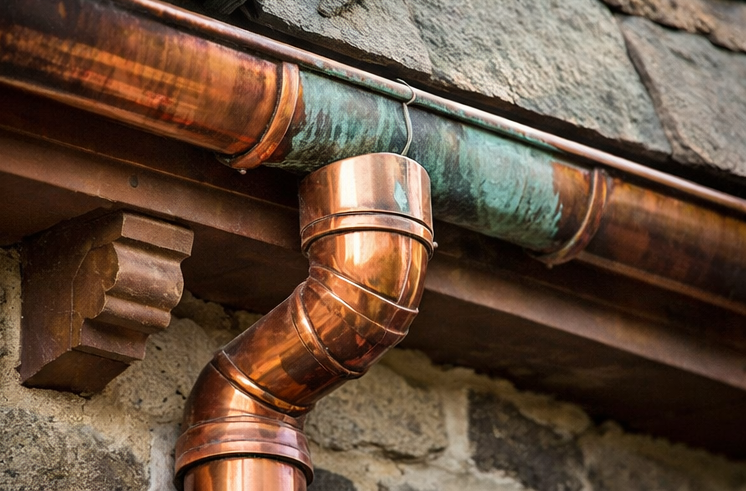 aged copper gutter with natural patina